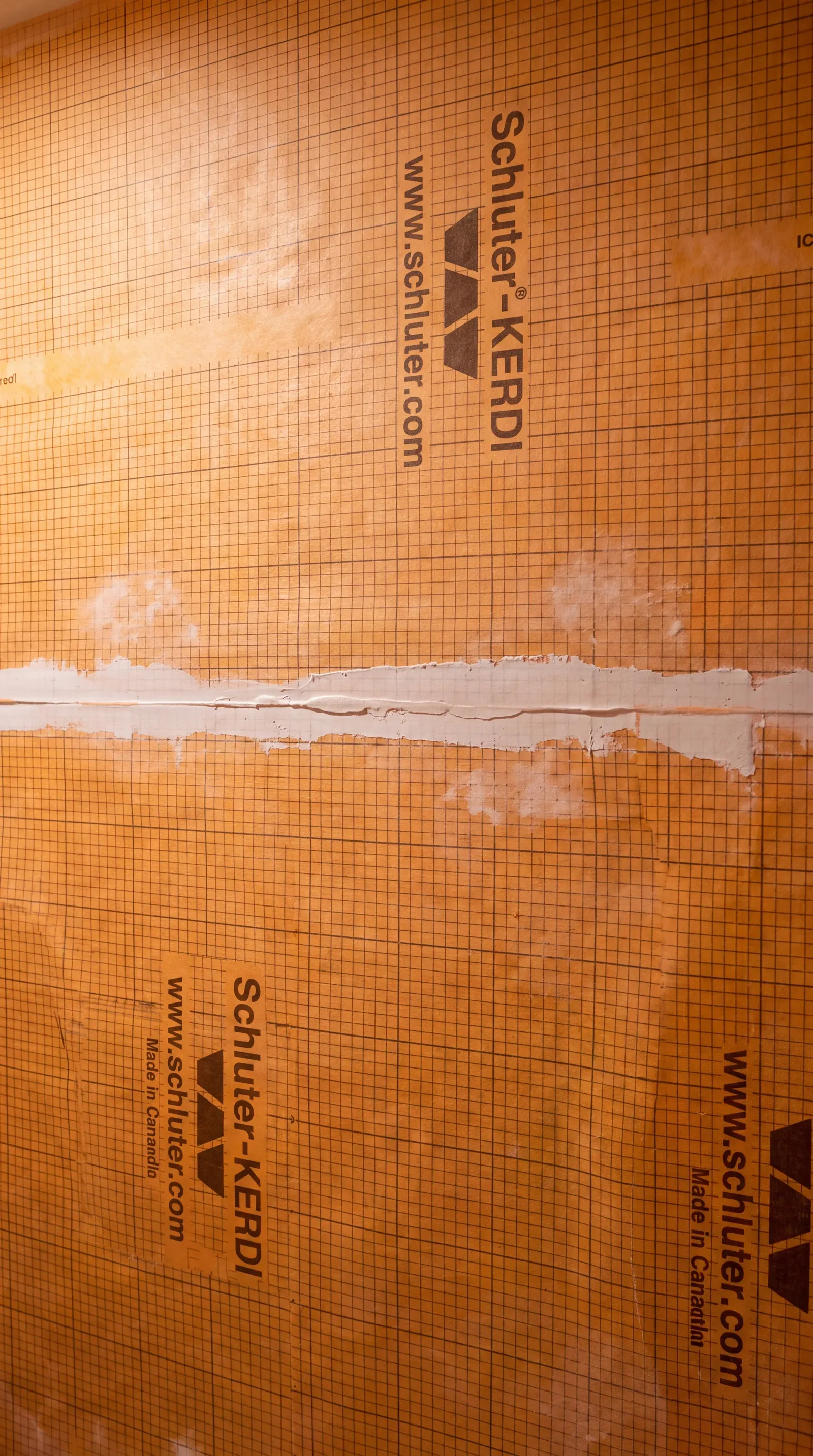 Continuous KERDI waterproofing membrane over the shower walls and pan