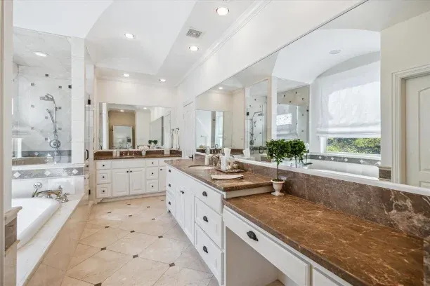 Before: Bathroom remodel in Barton Hills, Austin, TX with brown granite counters and a garden tub