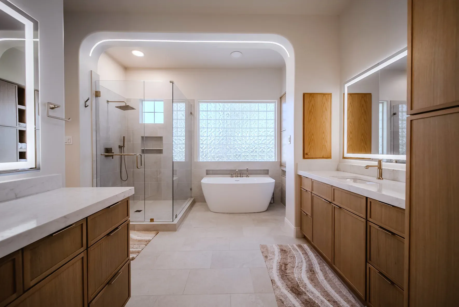Completed Enso primary bathroom near Lake Travis with freestanding tub, glass shower, and white oak vanities
