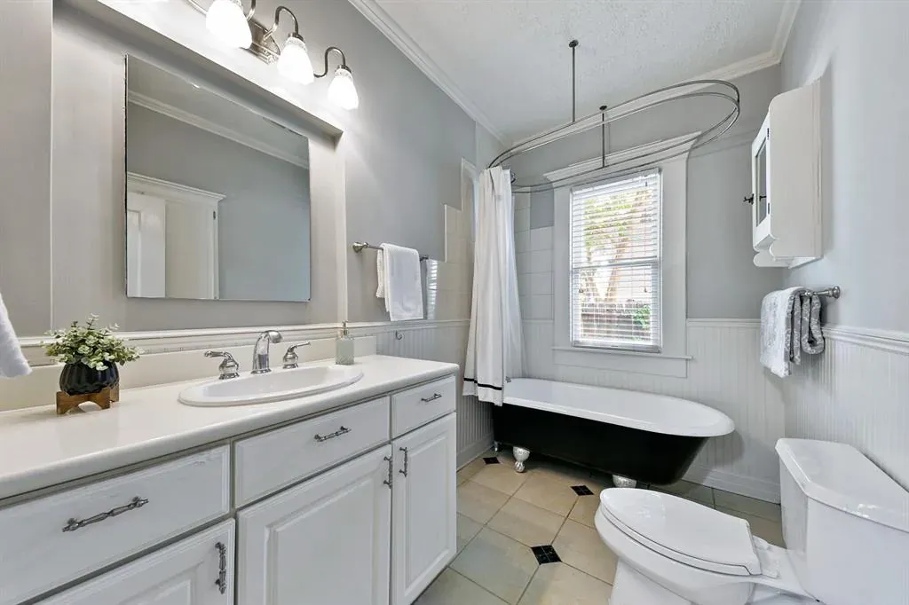 Before: Bathroom remodel in Tarrytown, Austin, TX with a clawfoot tub and a white vanity