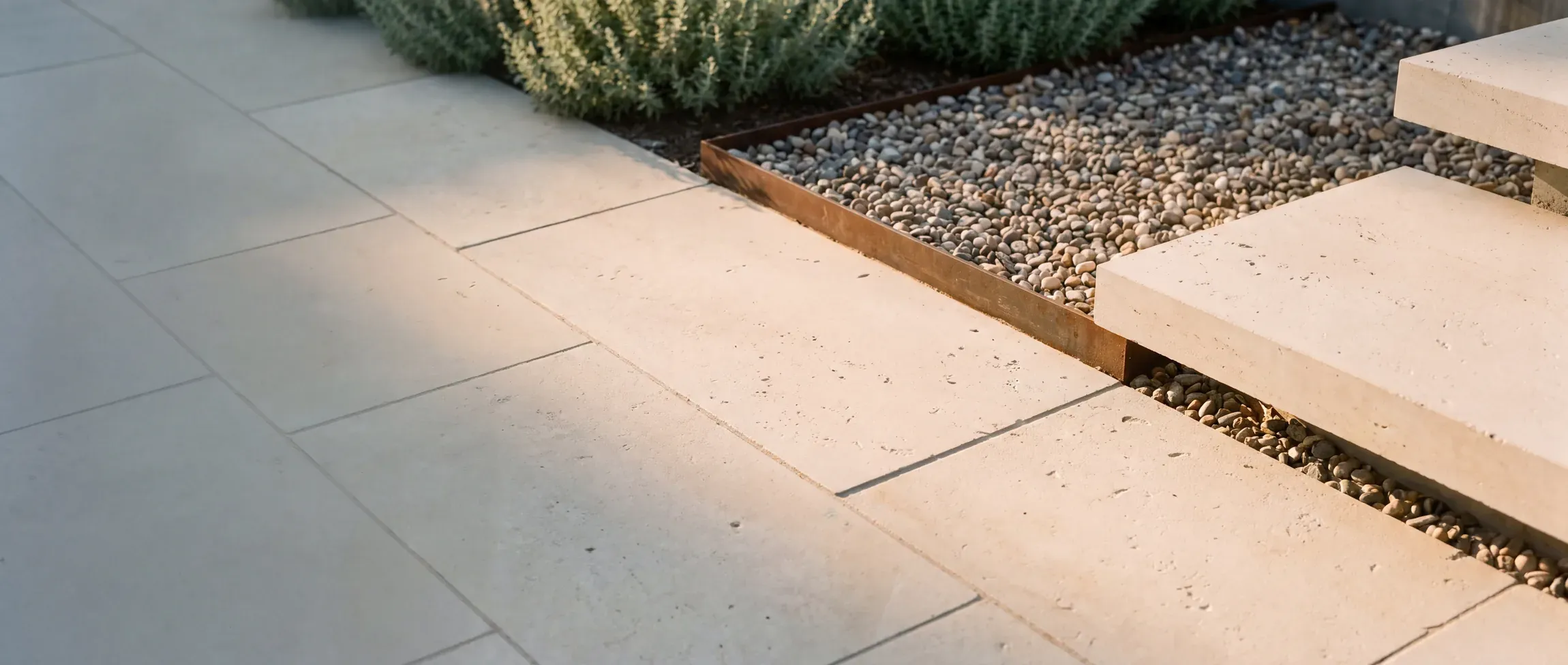 Limestone hardscape and a shade structure over a patio, set on an engineered base
