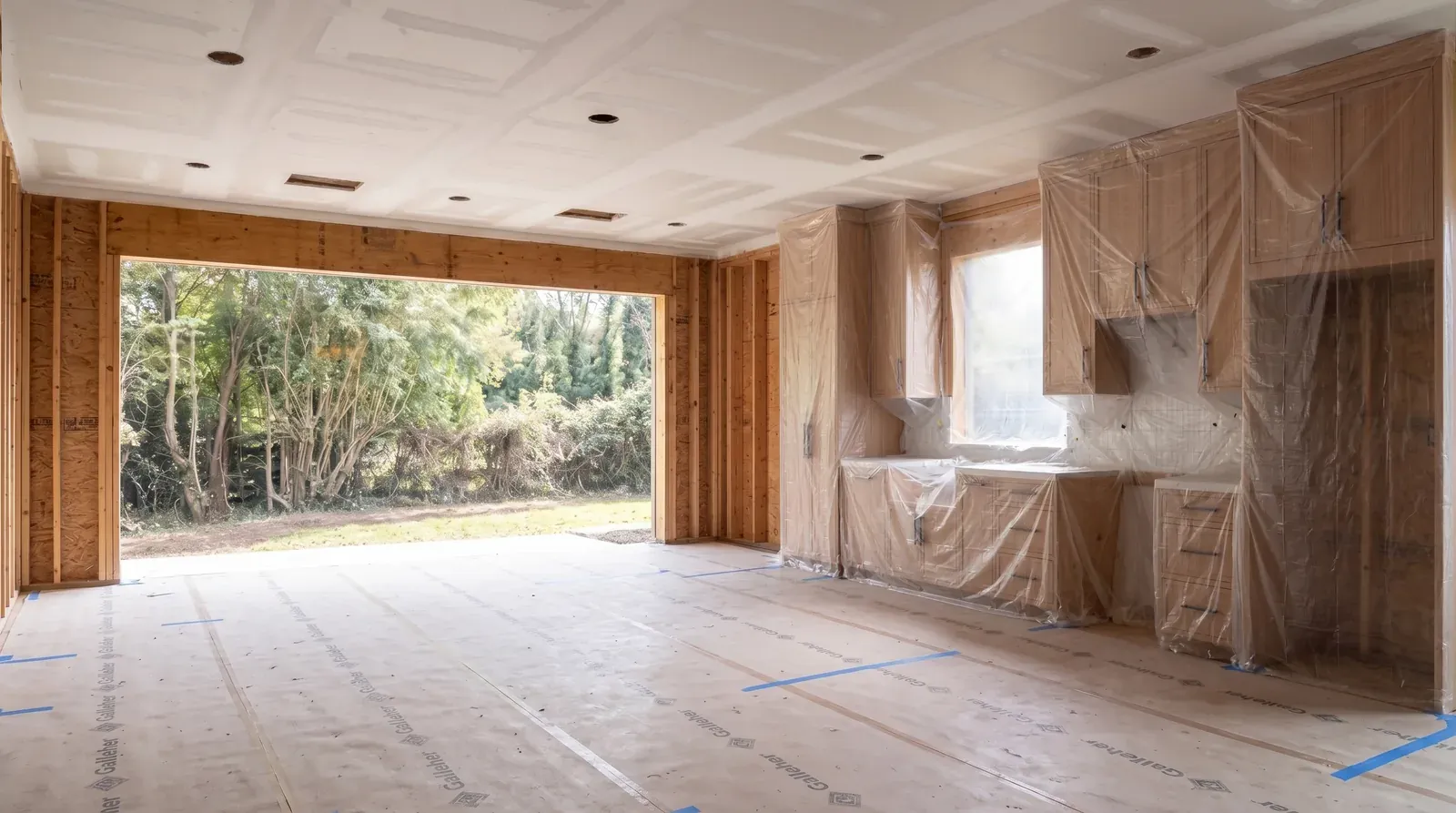 The same garage mid-build with new framing, insulation, and a reframed opening