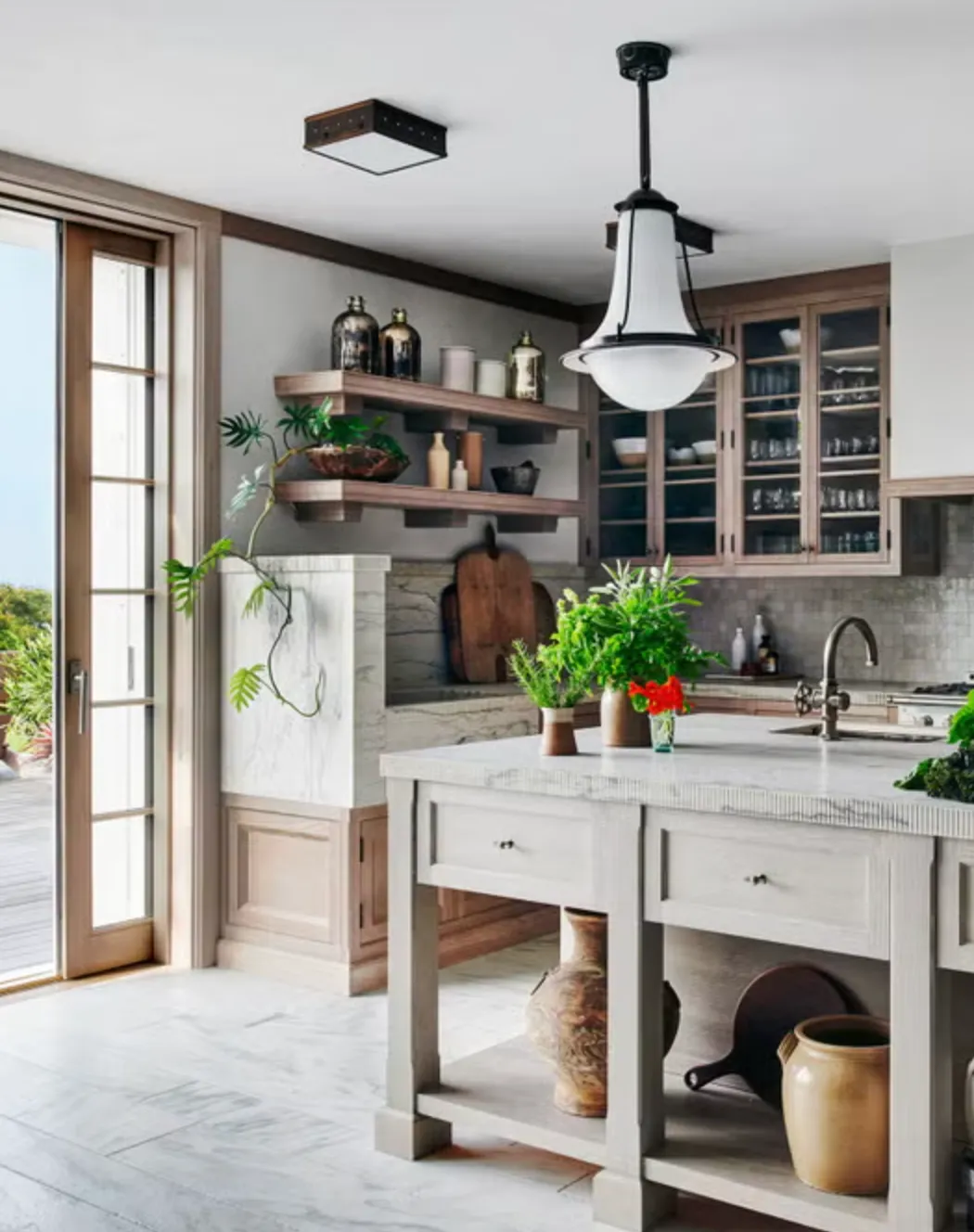 Remodeled kitchen with marble island and open shelving in Zilker