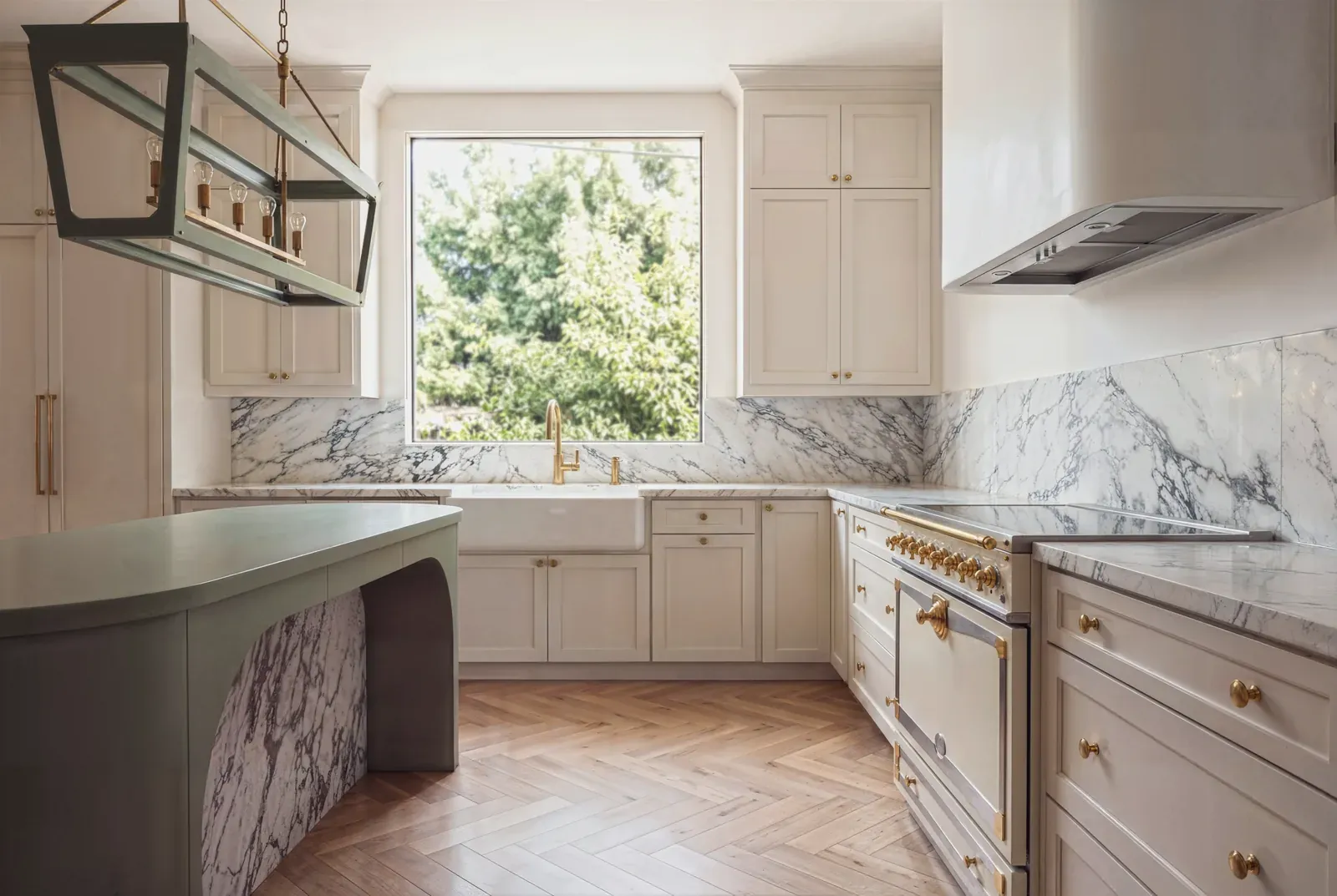Finished Clarksville kitchen with marble backsplash, sage green island, and herringbone oak floors