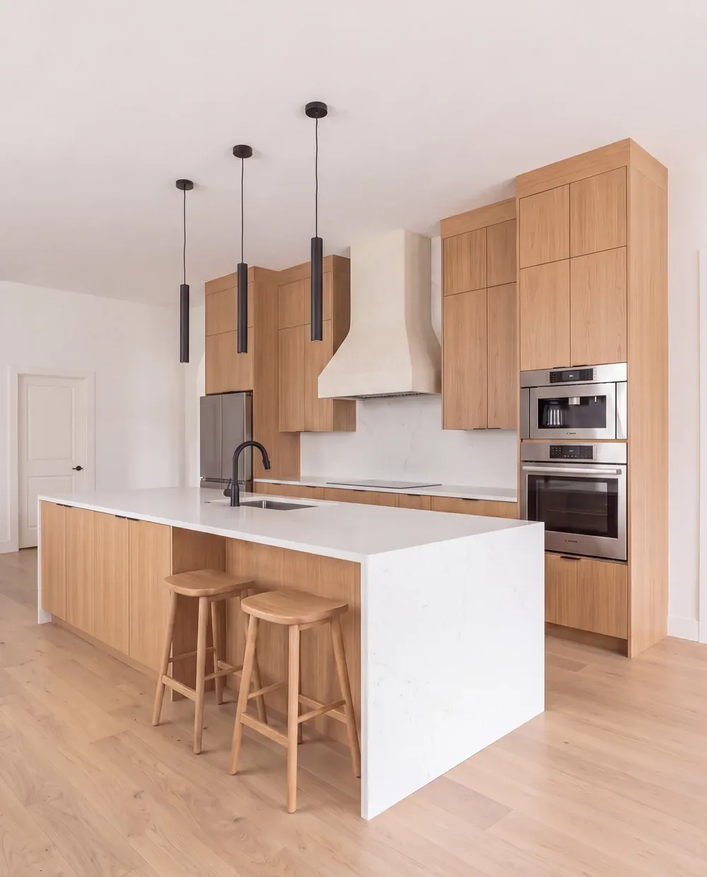 Rendering direction A: rift oak cabinetry with a quartz waterfall island in the existing kitchen layout