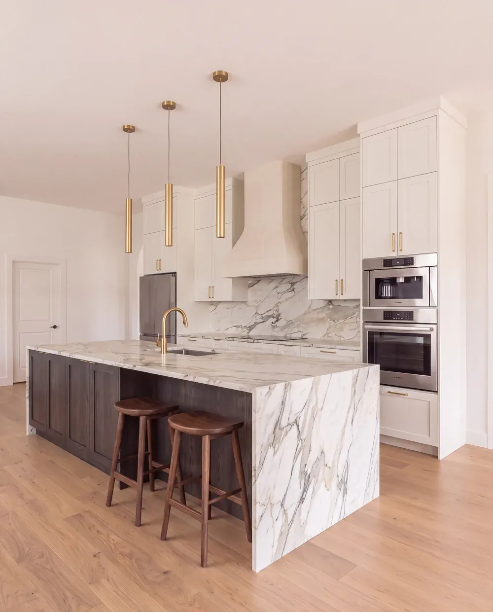 Rendering direction B: painted oak and walnut cabinetry with a book-matched marble waterfall island