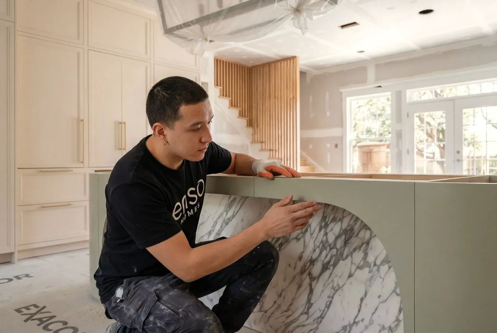 Enso craftsman making a final touch-up in a finished Austin kitchen