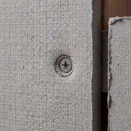 Cement board face with recessed corrosion-resistant screw