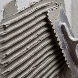 Freshly combed thinset mortar ridges with notched trowel edge