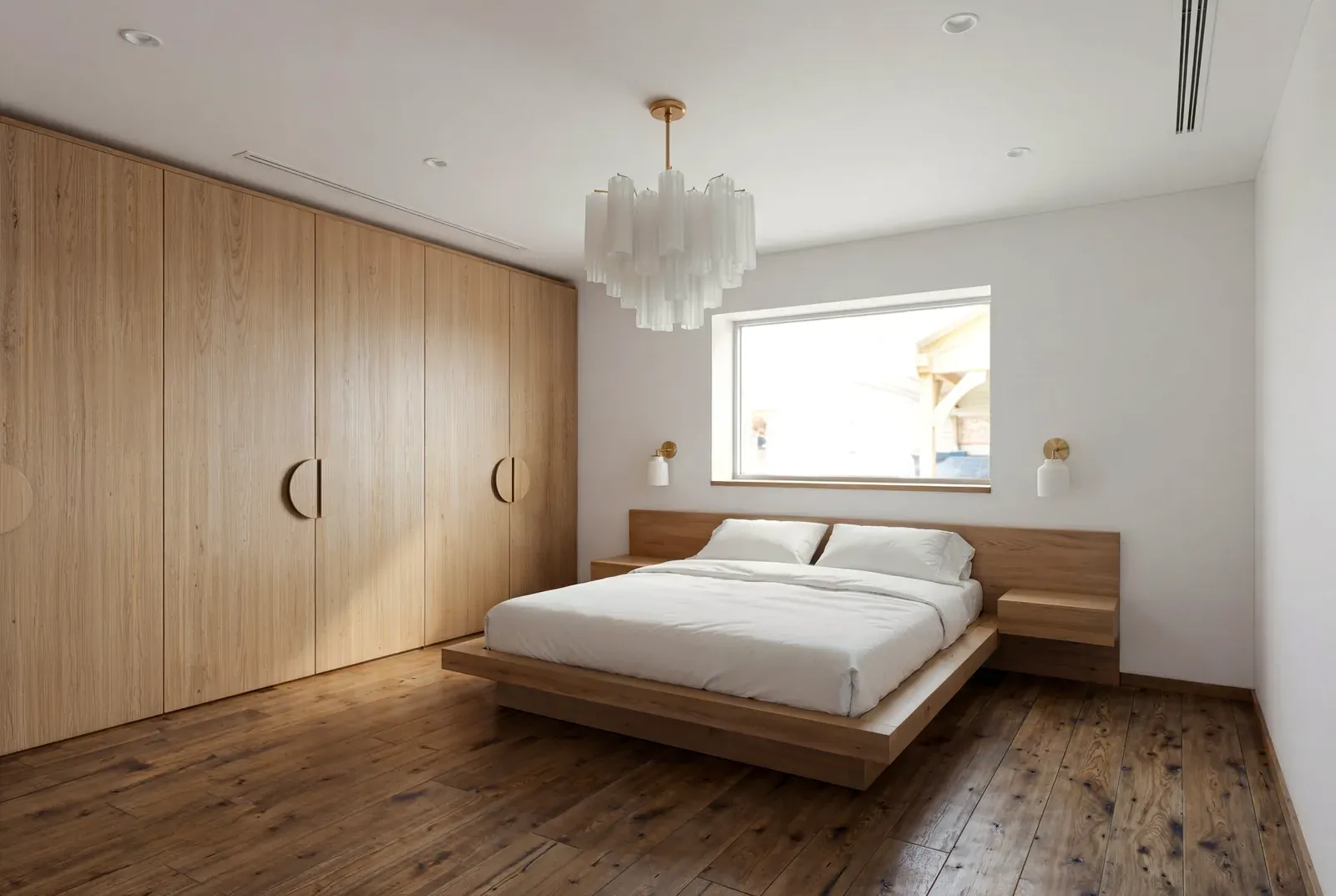 Whole home remodel in Mueller, Austin, TX with a white oak wardrobe wall and a platform bed