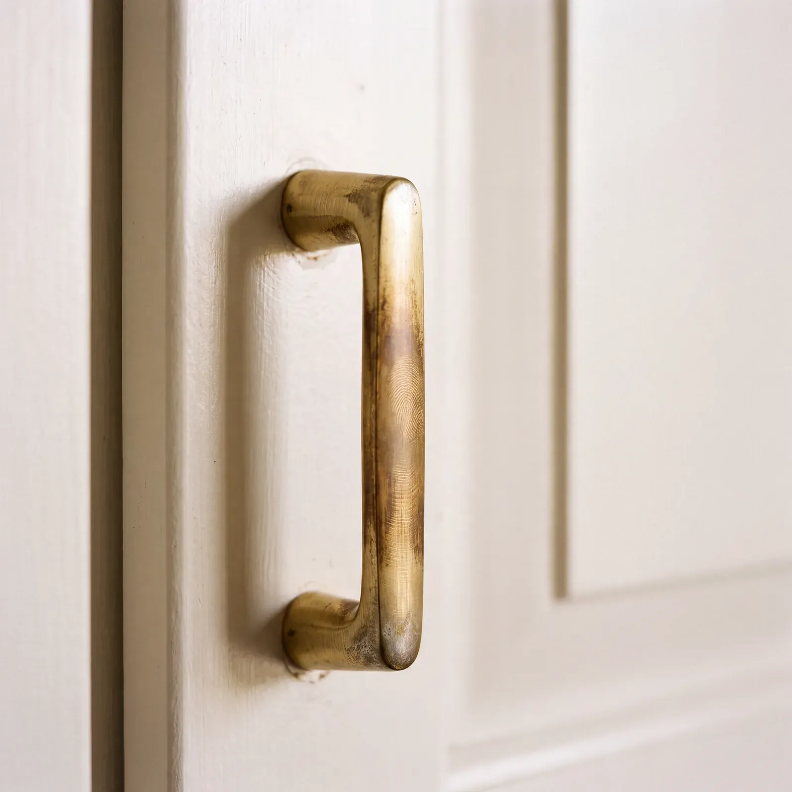 Unlacquered brass hardware sample with a warm, living finish